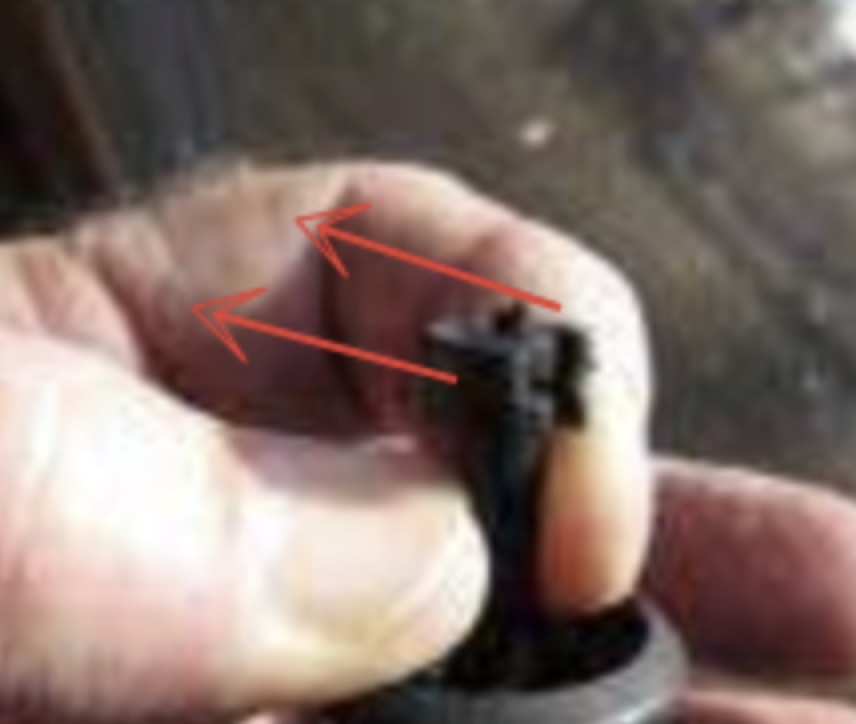 Close-up of clip with red arrows showing sliding direction